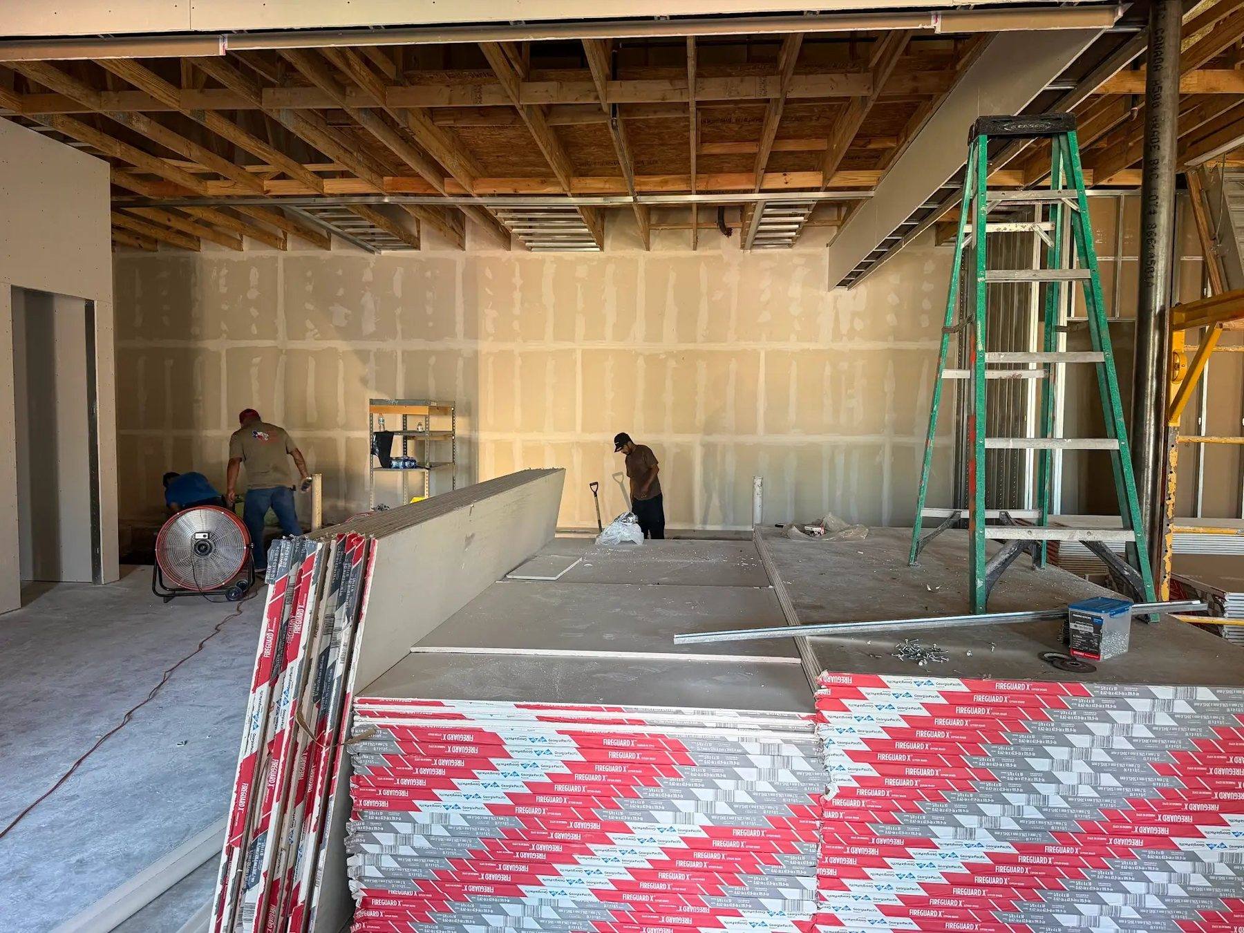 Drywall going up around the open agent area of the Aleaf Insurance office in Frisco, TX