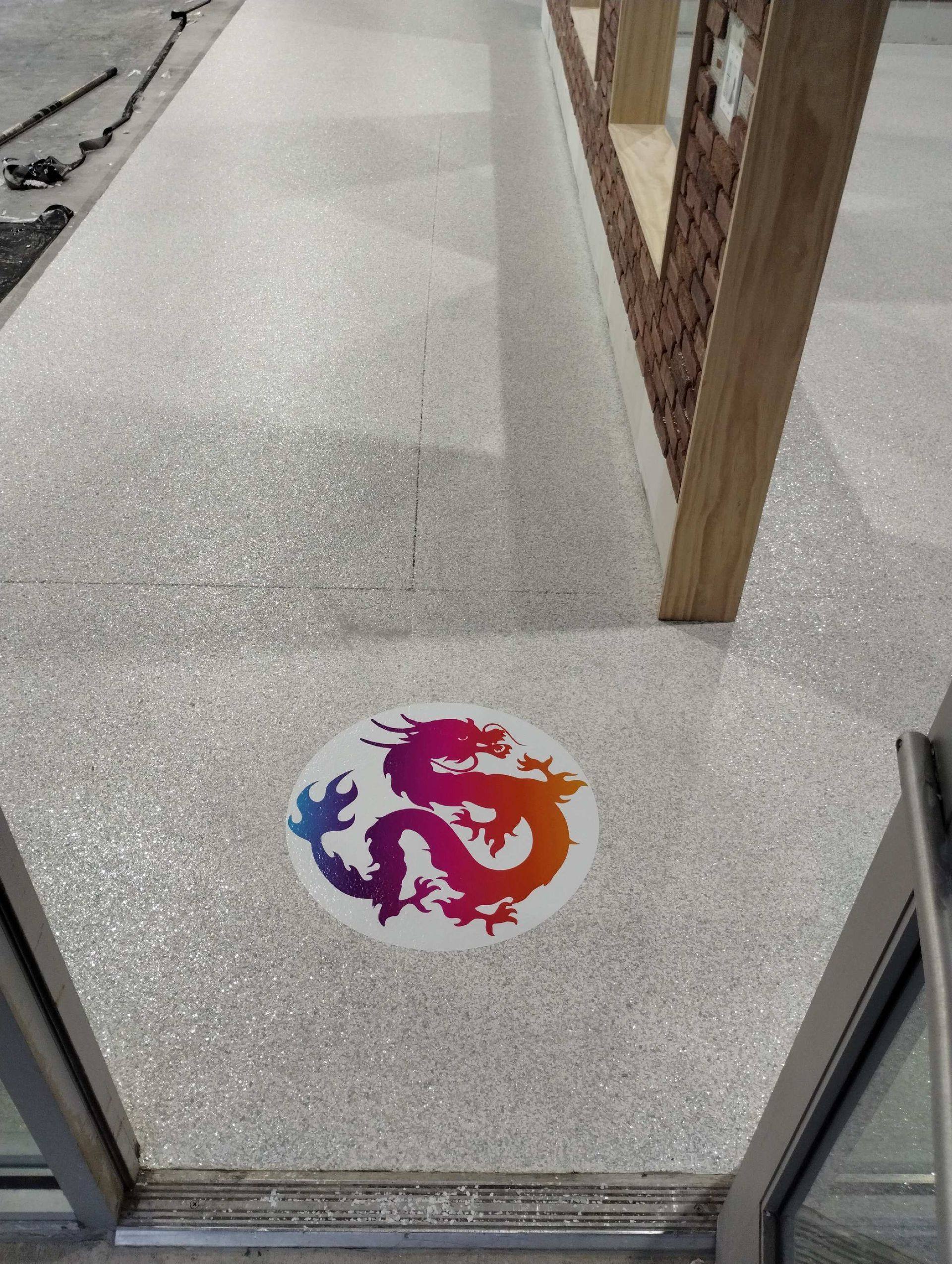 The dragon logo set into the finished epoxy entry floor at Kung Fu Academy of North Texas in McKinney, TX