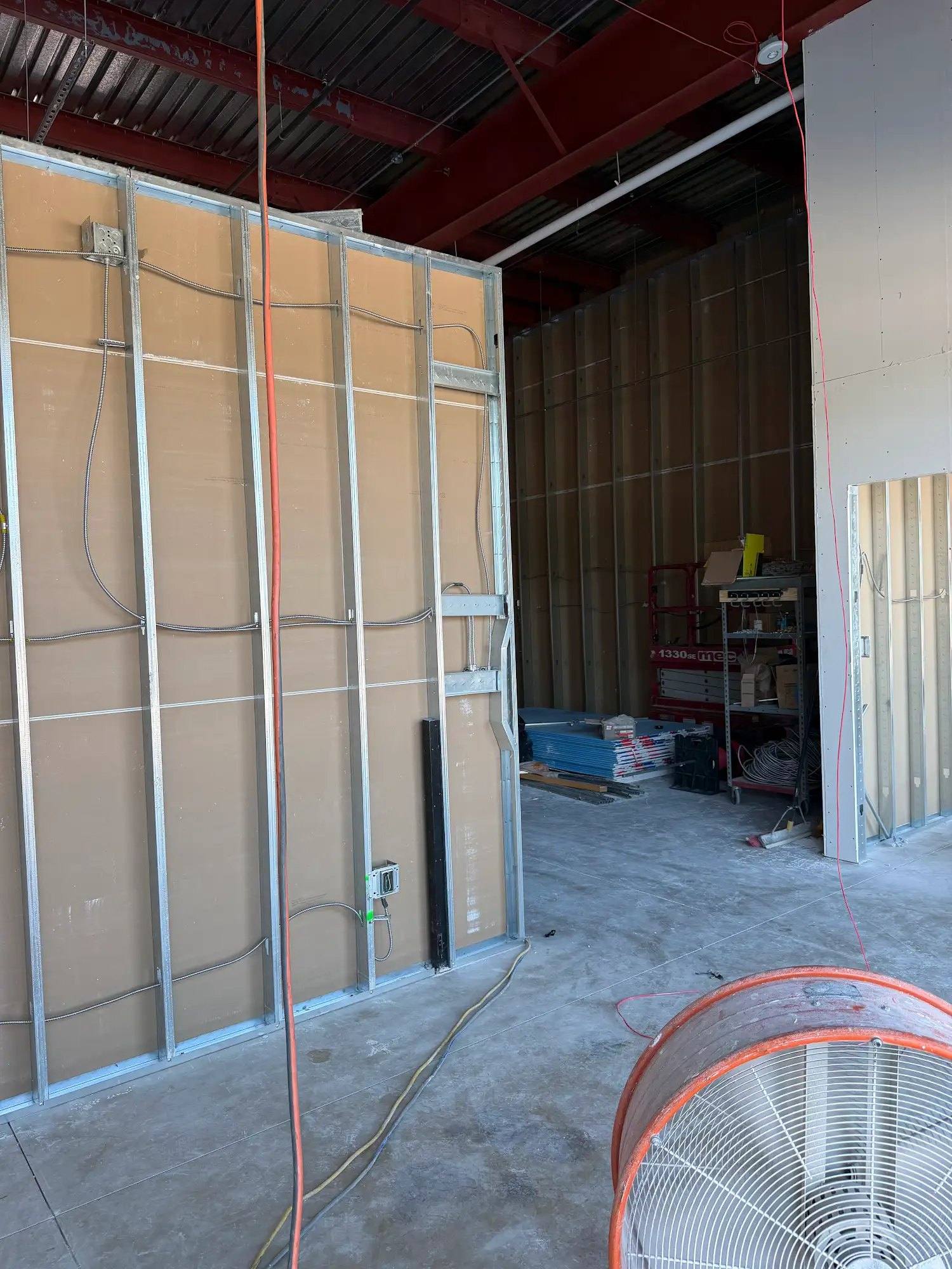 New interior wall framing and drywall going up to plan at Calibrate Pilates Studio in McKinney, TX