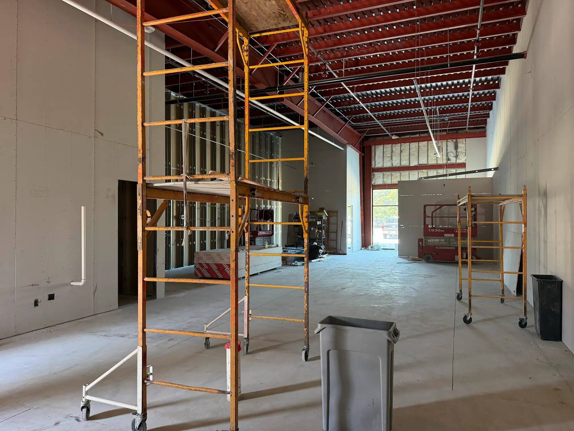 Calibrate Pilates Studio suite under construction in McKinney, TX, with new interior walls going up under an open roof deck