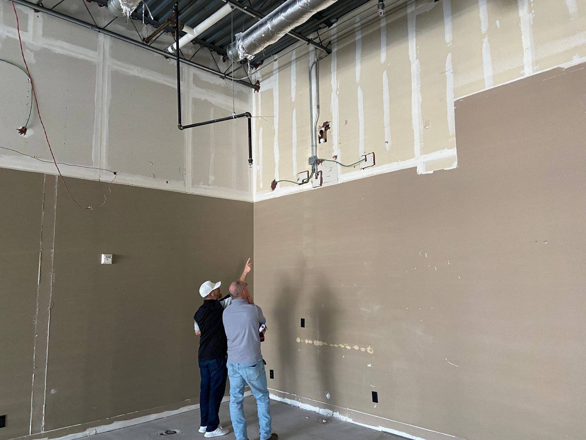 Before: green wiring on the back wall of the former dental office that became Rockstar Martial Arts in Frisco, TX