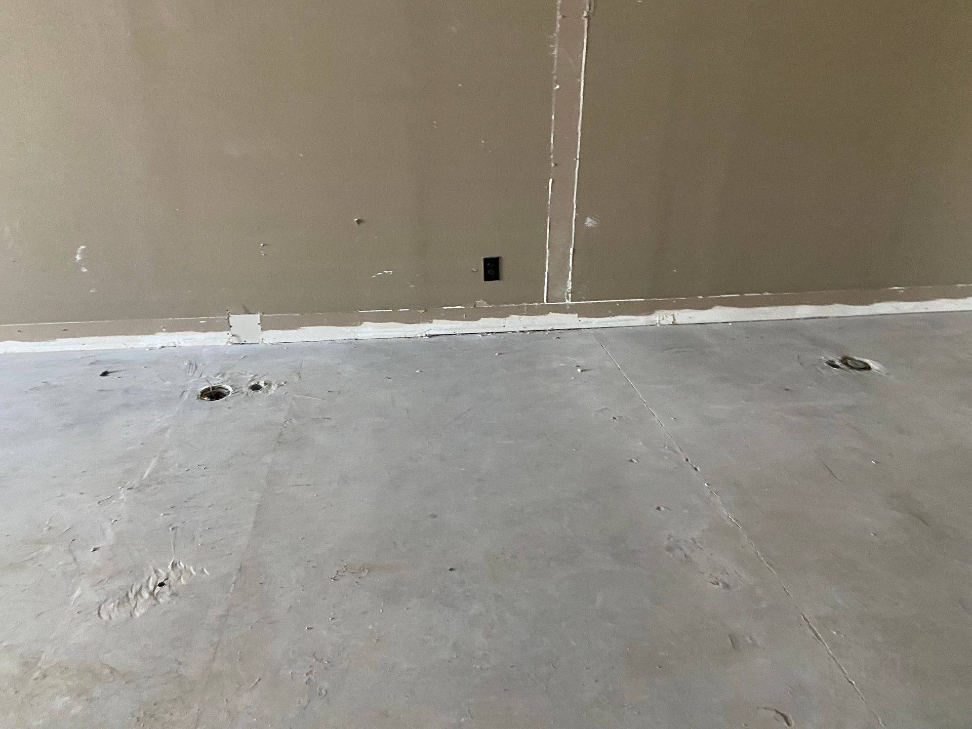Before: holes by the east wall of the former dental office that became Rockstar Martial Arts in Frisco, TX