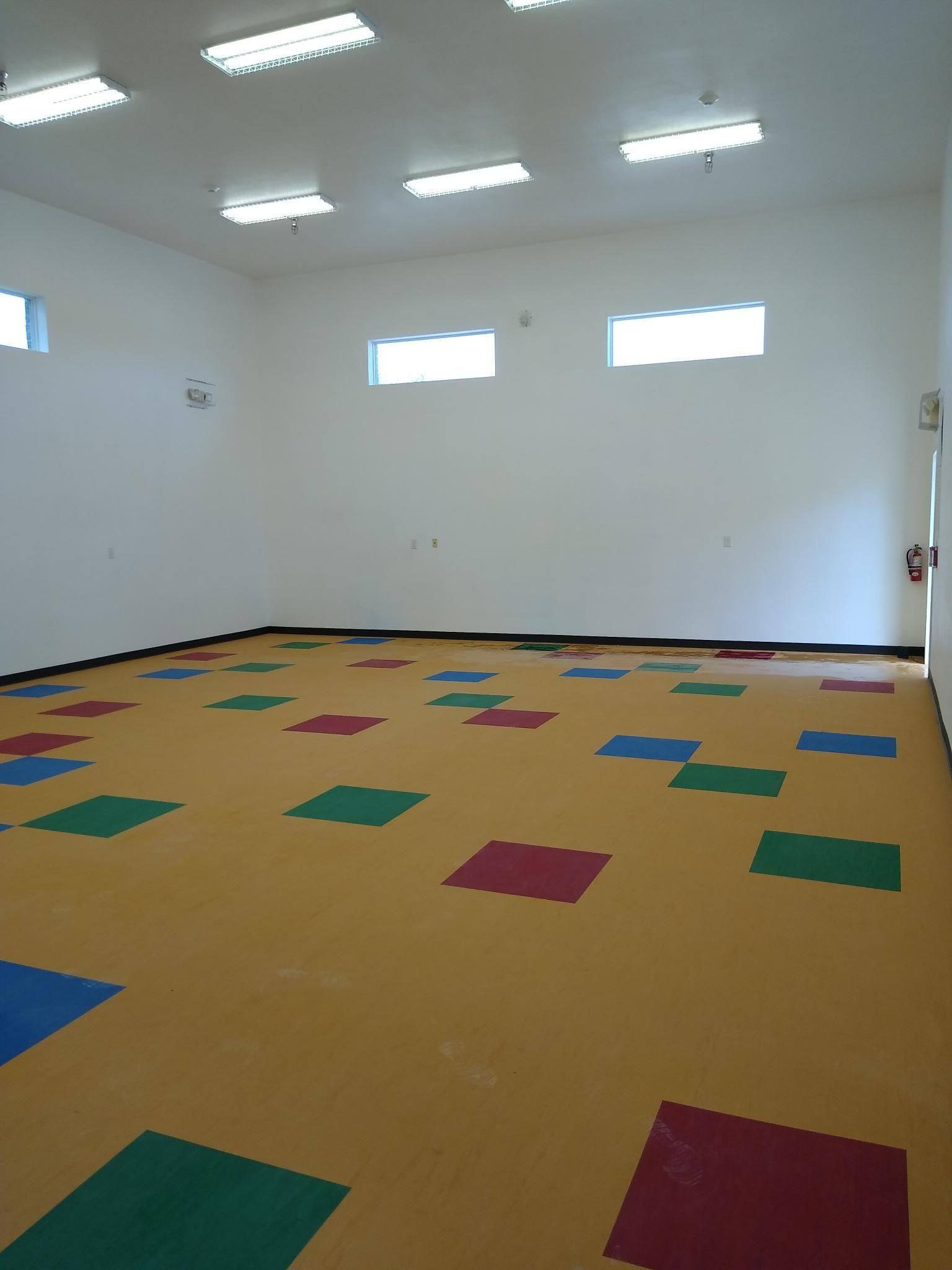 Another view of the recovered gymnasium in July 2021, showing the finished ceiling, lighting and floor NorthStar Commercial Interiors rebuilt