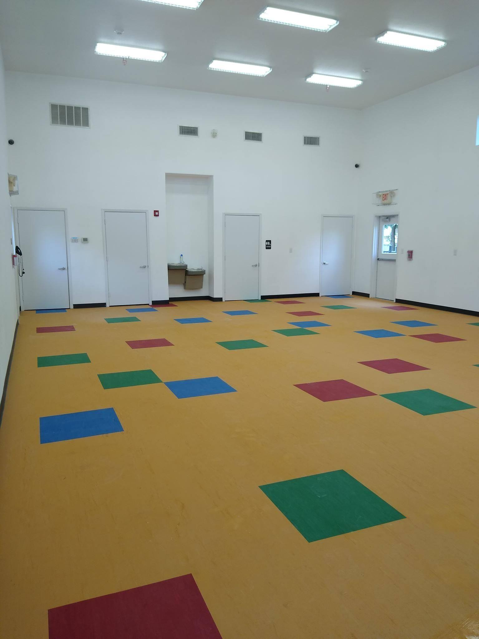 The gymnasium back in use in July 2021, with a new ceiling, new lighting and a new tile floor, five months after two pipes burst during the Texas freeze