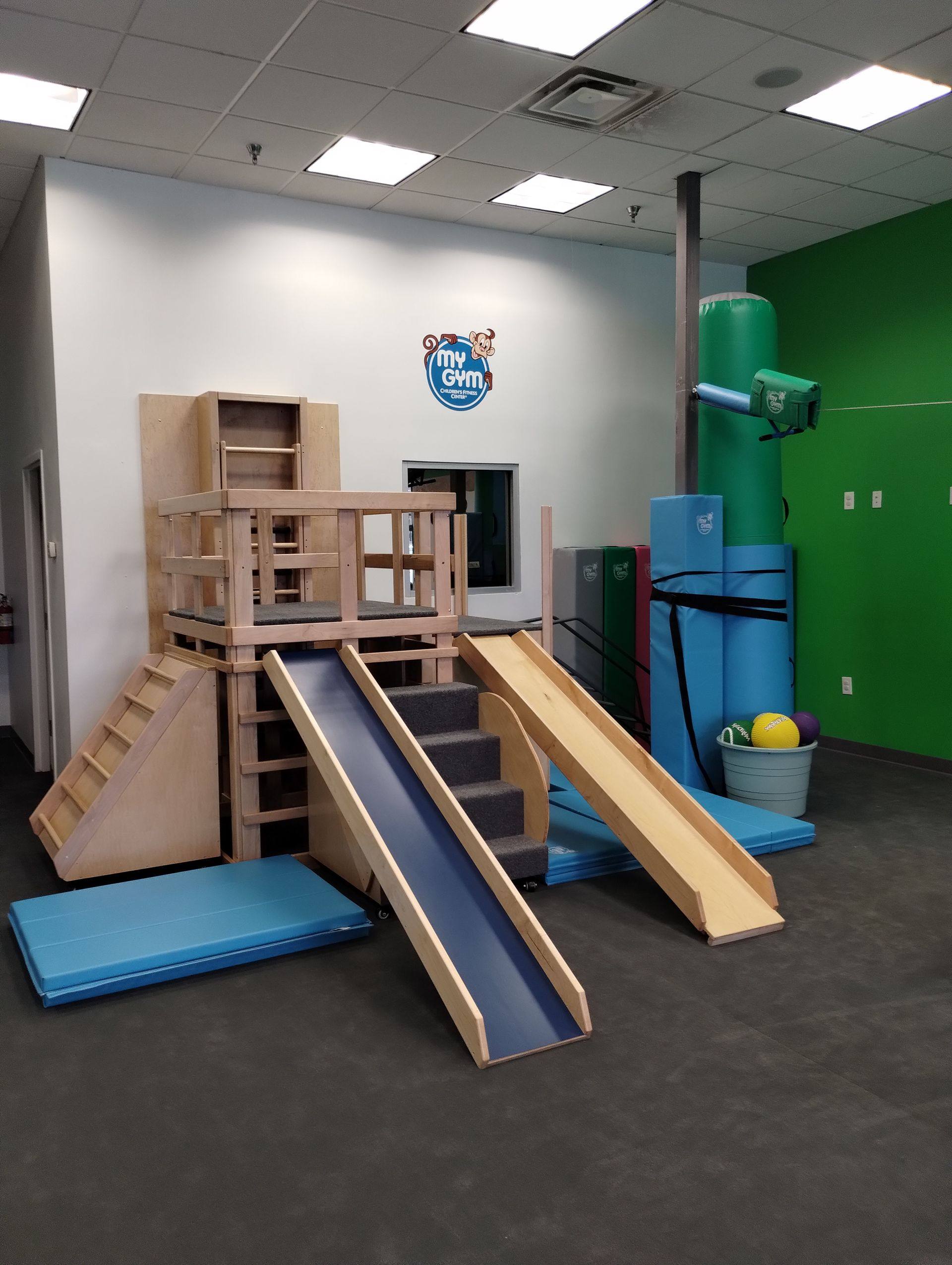 After: the finished play structure with its slides, steps and padding at My Gym in Allen, TX