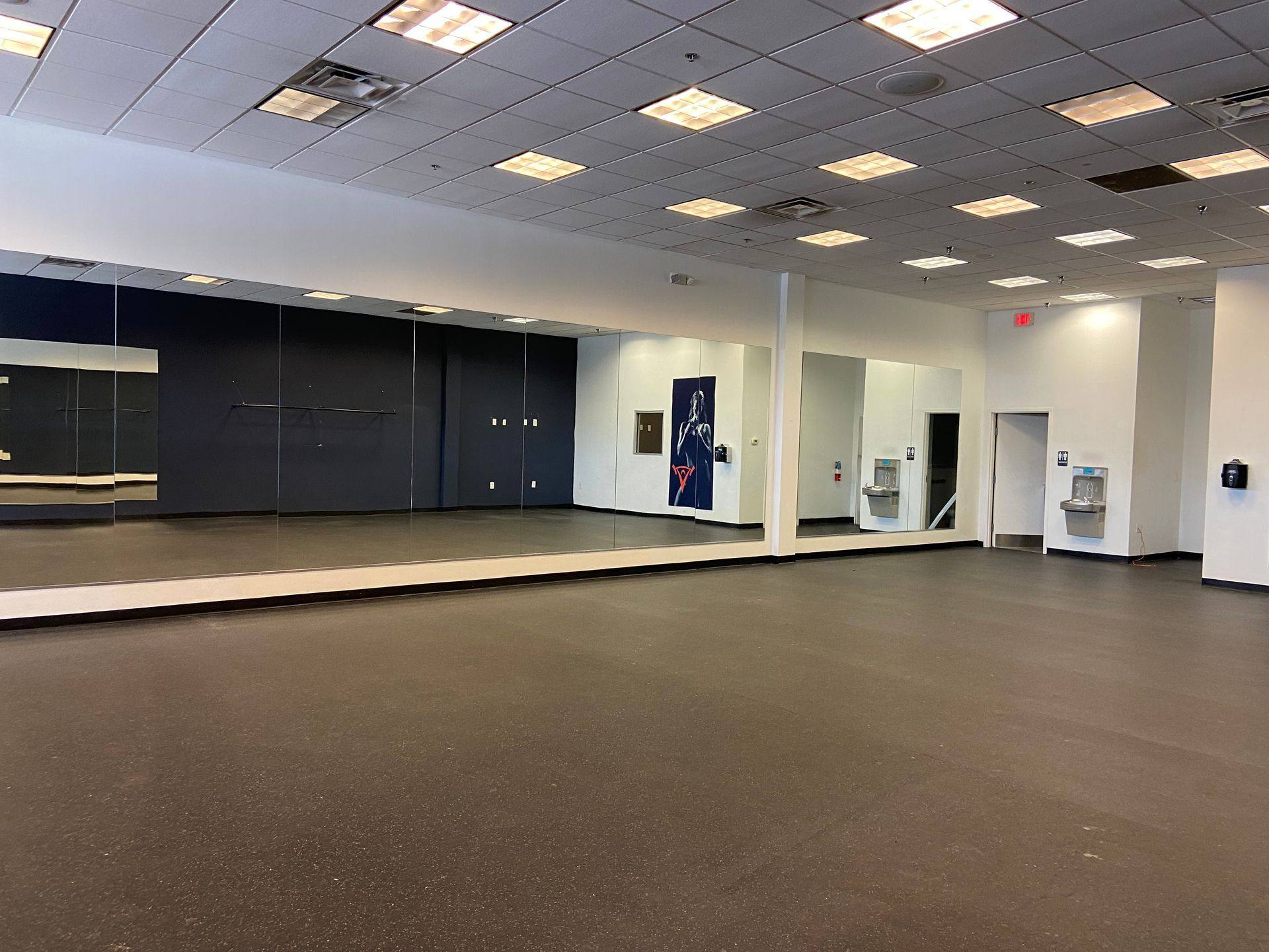 Before demolition: the mirrored wall removed during the My Gym remodel in Allen, TX