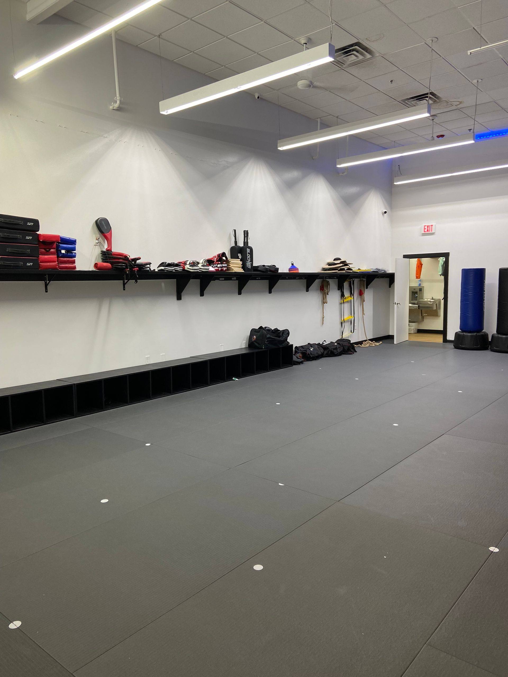 After: floating shelves in the finished training area at Professional Black Belt Academy in Prosper, TX