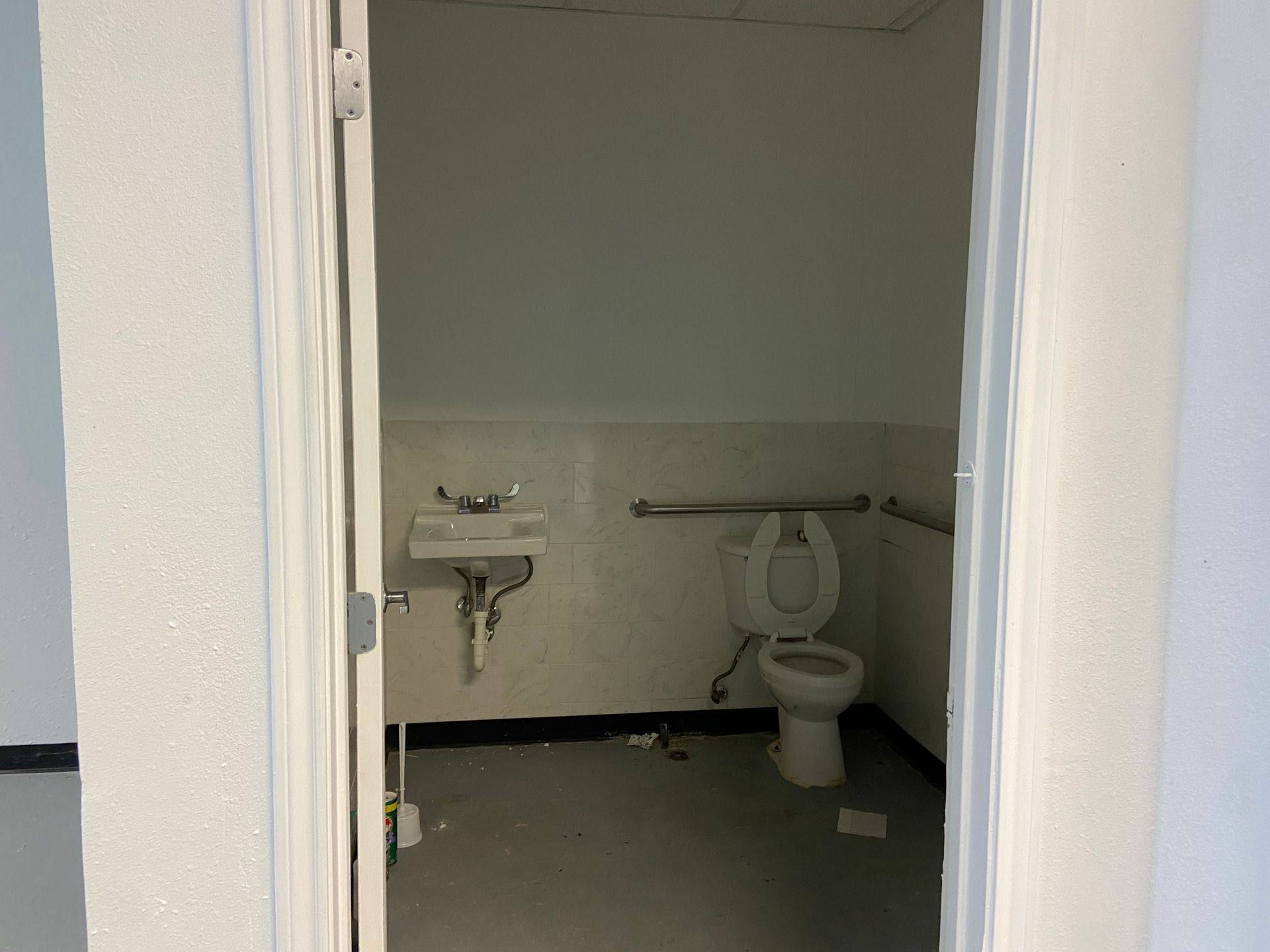Before: the existing rest room in the suite that became Kernetics Wellness Center in Little Elm, TX