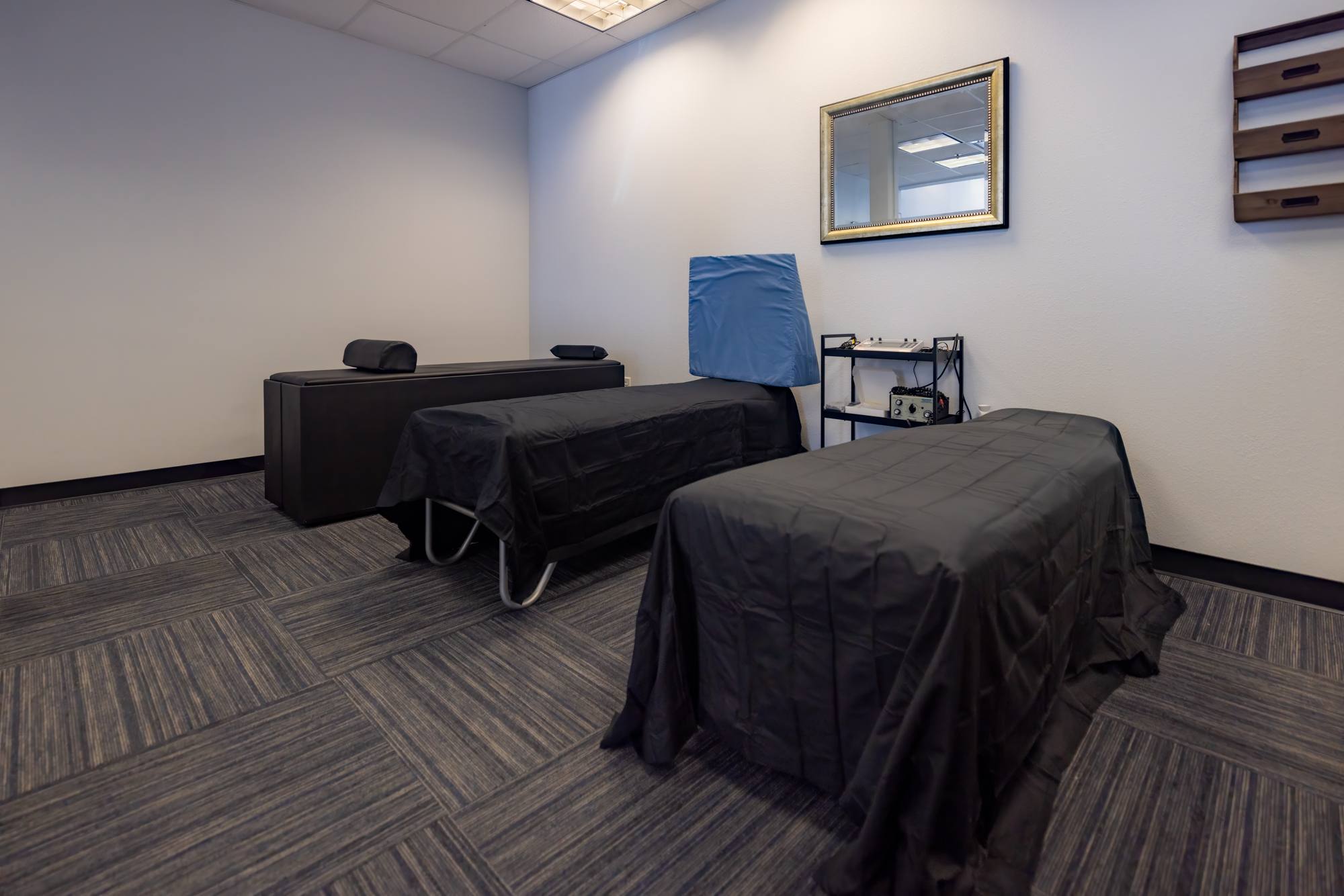 Finished chiropractic treatment room with adjusting bench and treatment tables at Kernetics Wellness Center in Little Elm, TX