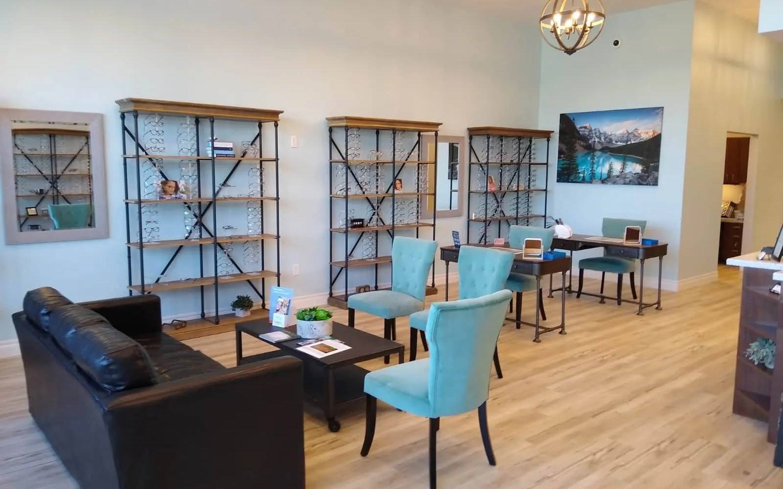 The finished optical showroom at Melissa Eye Associates in Melissa, TX, with frame displays, seating and fitting desks under the double-height ceiling