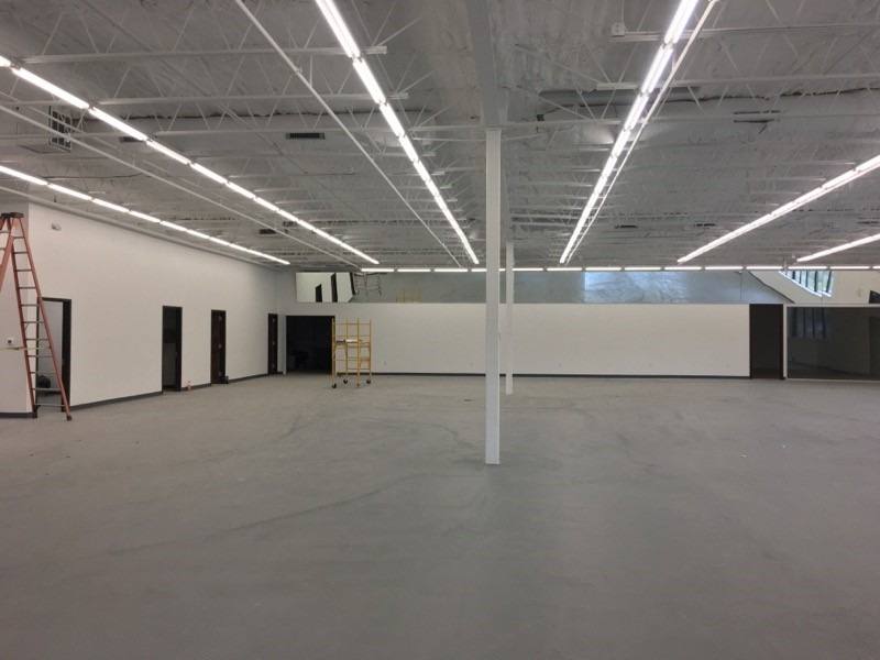 The finished sales floor at Nails Plus, renovated by NorthStar Commercial Interiors, with new lighting, a painted ceiling and a sealed concrete floor